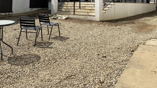 A courtyard with a white building, outdoor seating, and a staircase leading to the entrance. - Motel like en suite room, own front door. Secure parking. 1 mile to crewkerne (Crewkerne)