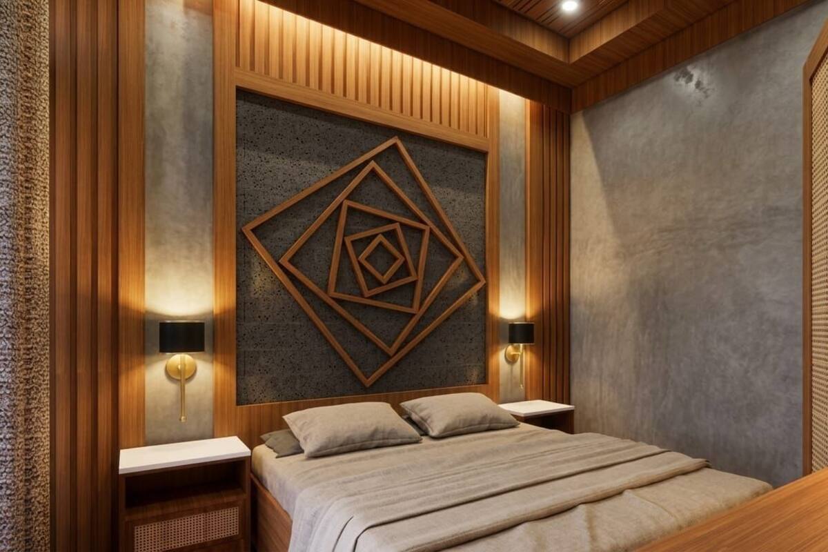 A bedroom with a bed, wooden paneling, a geometric wall art, two bedside lamps, and a nightstand.