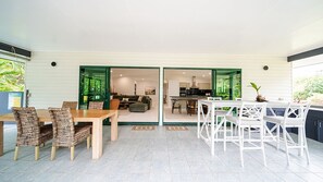 A modern interior with a dining area, a living room, and a kitchen. - Beachside on Pacific (Mission Beach)