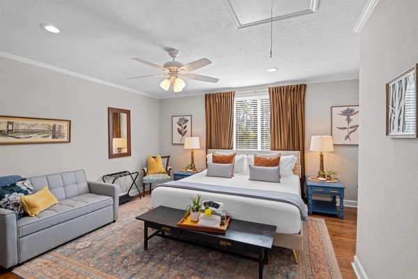 Primary bedroom with King bed, sleeper sofa, and private bathroom