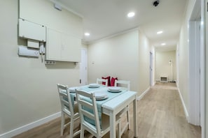 A dining area with a table set for four, white chairs, and a light blue tablecloth. - STUDIO 3 NEXT TO THE RAMBLAS OF BARCELONA (Barcelona)