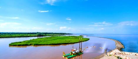 A river with a boat and a construction site.