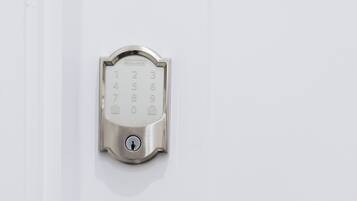 A modern door with a numeric keypad lock and a lever handle.