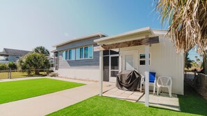 A modern house with a covered patio, a lawn, and a pool. - Waterfront Escape • Private Dock • Near 3 Sisters Springs (Crystal River)