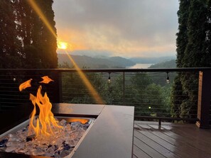 A fire feature with a view of a sunset over a lake and mountains. - Hiwassee Lake Lodge - Private Mtn-Top Retreat - Lake Views - Sleeps 13 (Murphy)