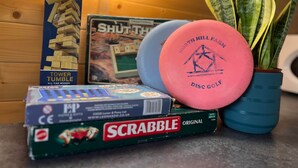 A Scrabble box, a Tower Tumble game, a Shut Thuh game, and a pink disc golf disc. - Dinky Disc - Cosy Hot Tub Escape (Chorleywood)