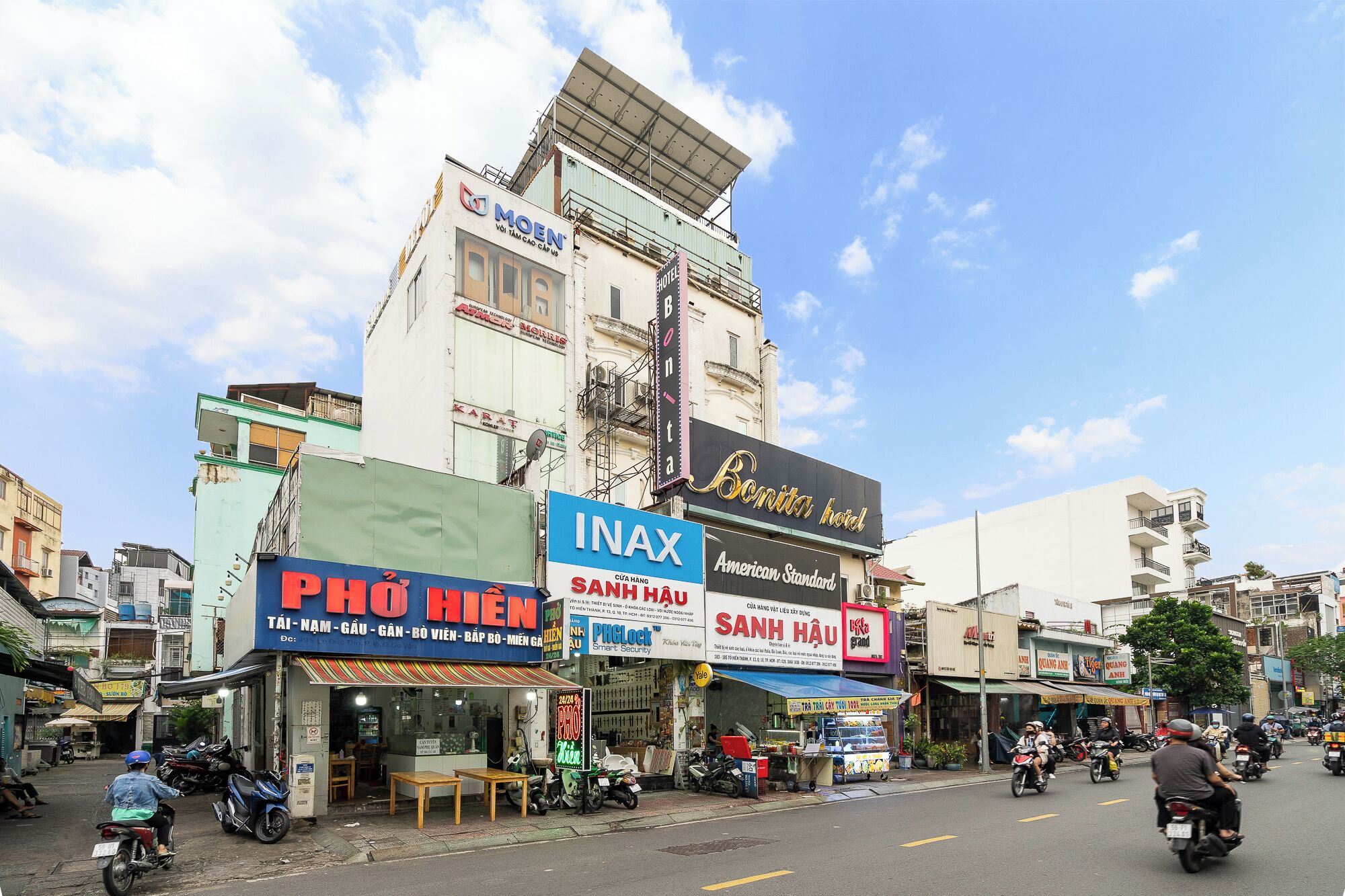 Vista de la calle con diversos comercios, incluyendo un hotel, un cine y un restaurante.