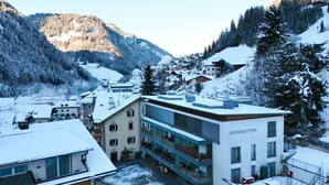 A snow-covered town with a modern building labeled 'MARIENSTERN' and traditional buildings in the background. - 1010A Marienstern Apartments (Santa Cristina Valgardena)