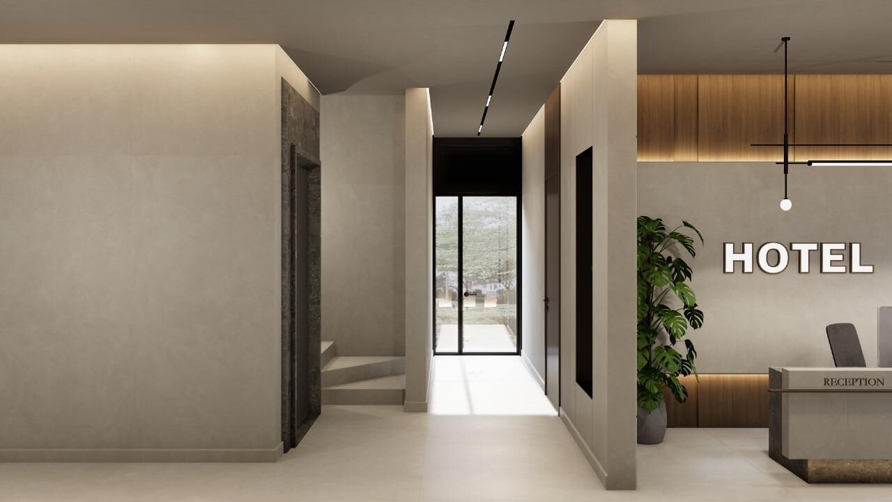 A hotel reception area with a reception desk, a plant, and a large window.