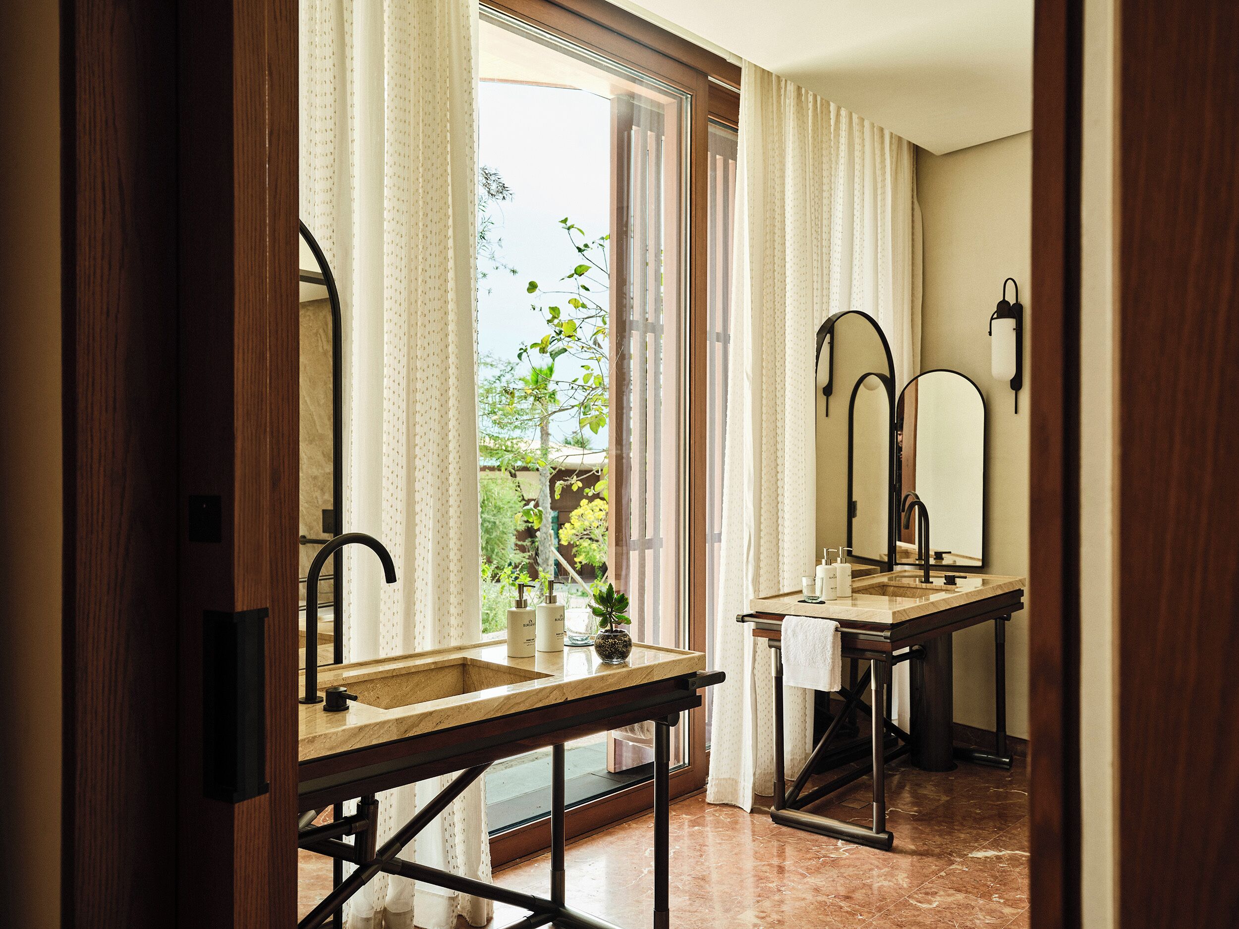 A bathroom with a sink, mirror, and window.