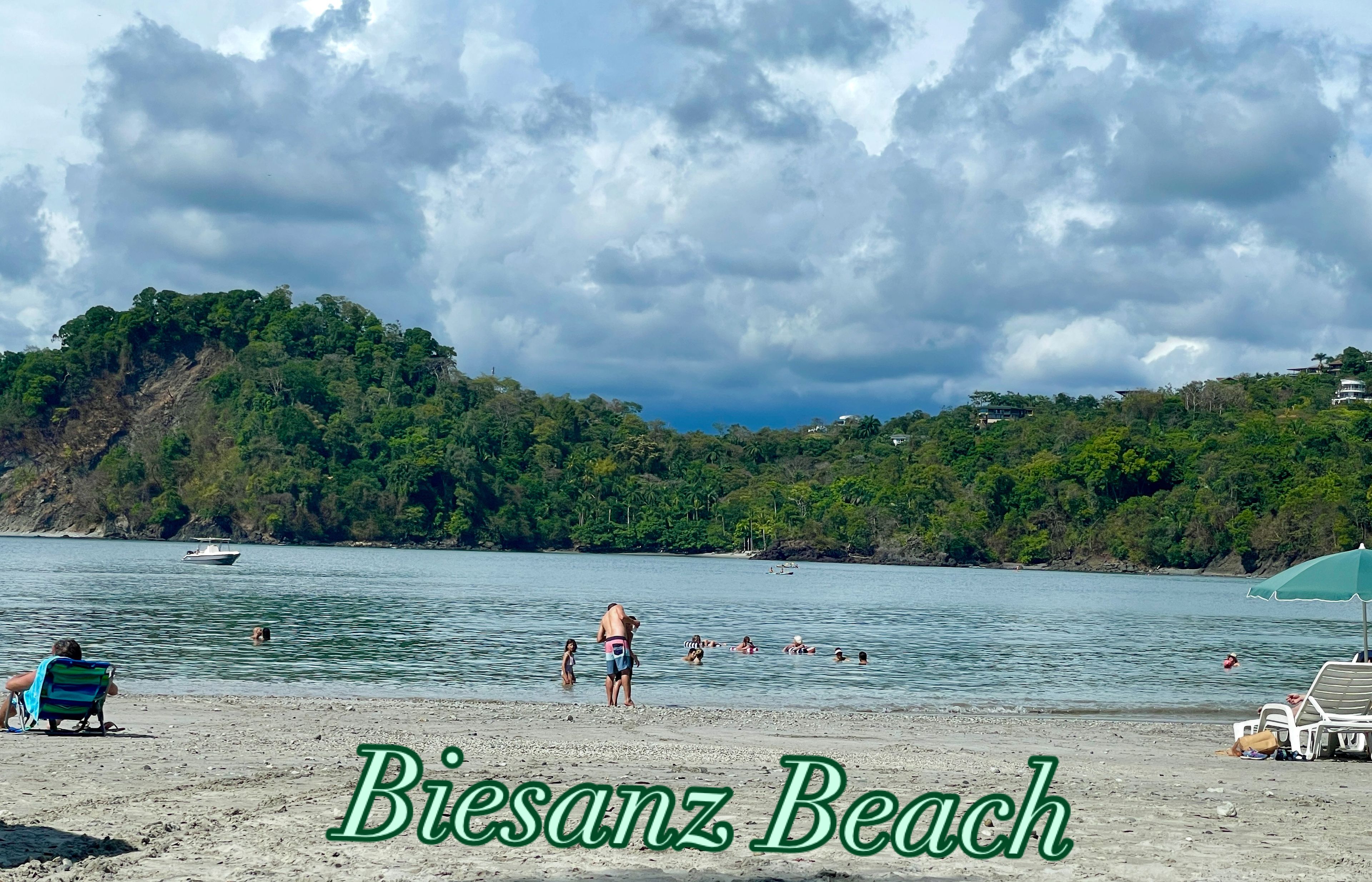 A beach scene with a sign stating "Biesanz Beach 30 minutes from Paraiso".