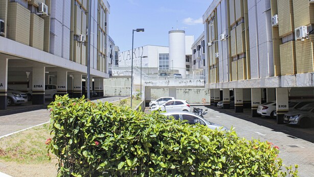 A parking garage with multiple levels and a central cylindrical structure. - Apartamento Toscana (Brasília)