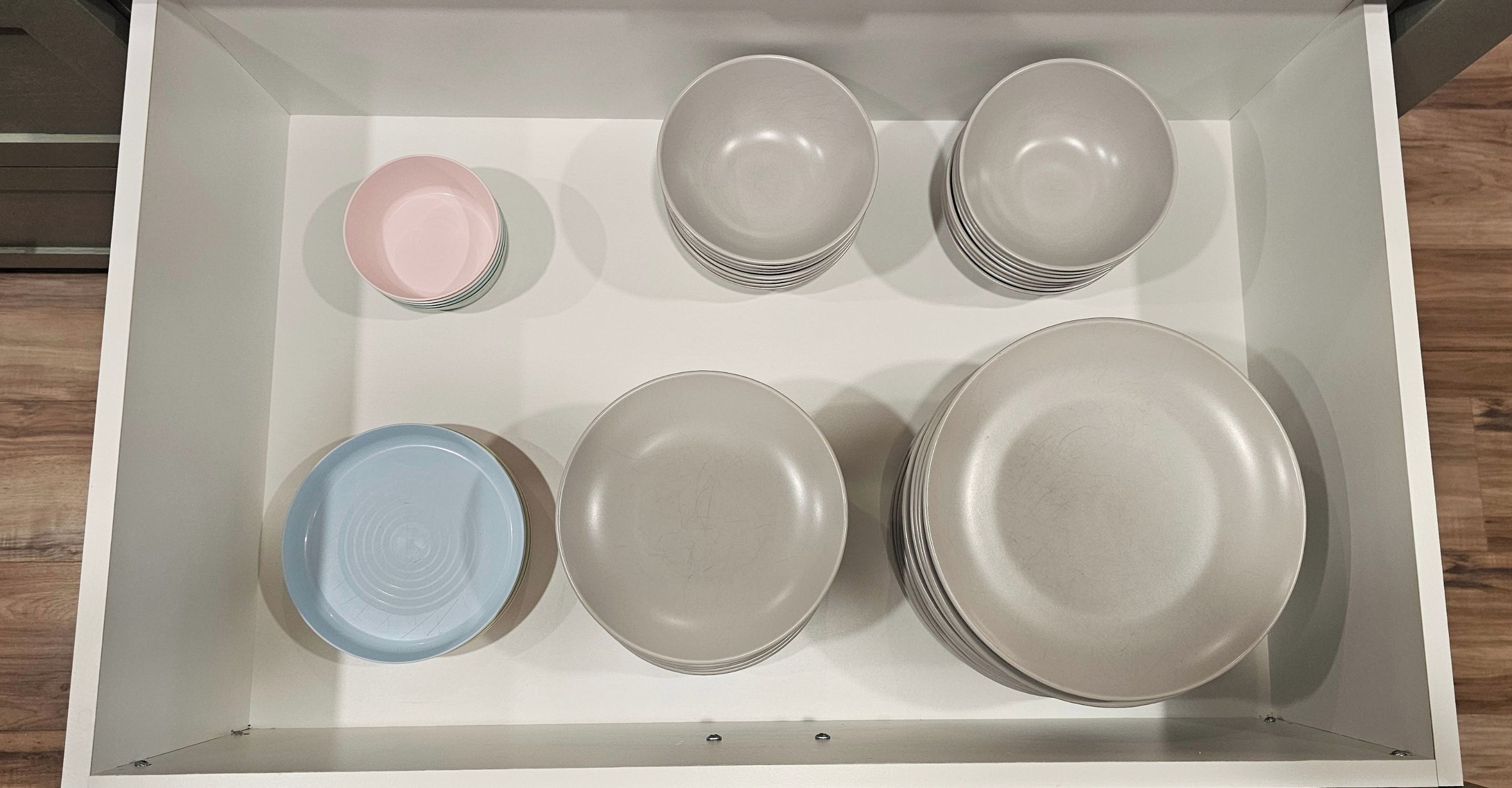 A storage box containing various plates and bowls.
