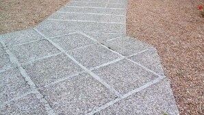 A stone pathway leading to a building with a green awning labeled "RECEPTION." - le relais cicero (La Flèche)