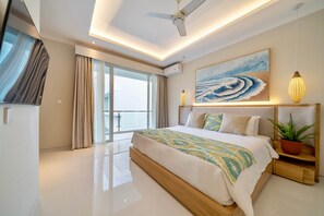 A modern hotel room with a large bed, a ceiling fan, a painting, and a potted plant. - New Modern, 2Br Villa in Canggu/Pool/Rooftop (Tabanan)