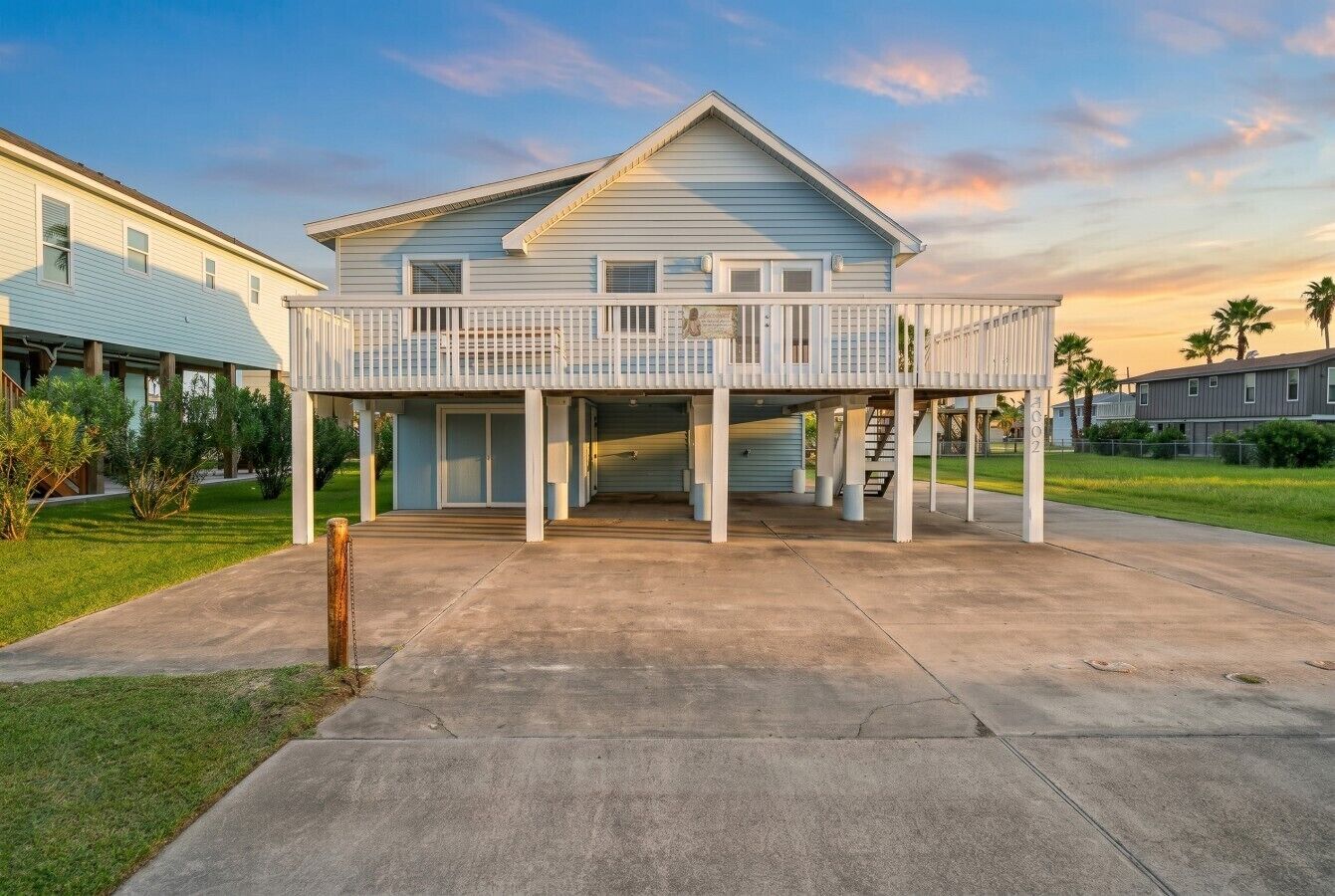 A two-story house with a covered porch and a garage.