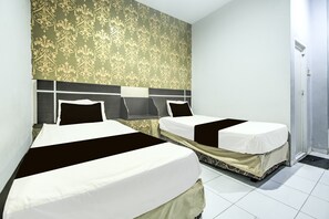 A hotel room with two beds, a patterned wallpaper, and a door to the right. - Hotel O Makassar near Mall Panakukang formerly Hotel Lucky Inn Makassar (Makassar)