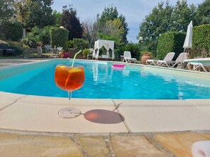 A swimming pool with lounge chairs and a white gazebo in the background. - THE BAGGIORO HOUSE (Capannori)