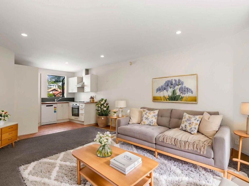 Stylish open-plan living room with kitchen and artistic decor