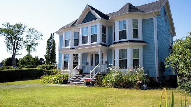 A large, two-story house with a prominent front porch and a staircase leading to the entrance. - The Granville Affair (Bridgetown)