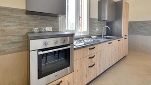 A modern kitchen with a built-in oven, a stovetop, and a sink. - PANORAMA - Elegant villa in a panoramic position! (Floridia)