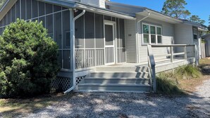 A single-story house with a covered porch and a chimney. - Spacious 5-bedroom "double house" in amazing Santa Rosa Beach with heated pool (Santa Rosa Beach)