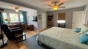 A bedroom with a large bed, a desk with a chair, a bookshelf, and a ceiling fan. - Spacious 5-bedroom "double house" in amazing Santa Rosa Beach with heated pool (Santa Rosa Beach)