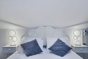 A bedroom with a bed, two bedside tables, and wall-mounted lighting. - The Poconos Fun Chalet w/Game Room (Tobyhanna)