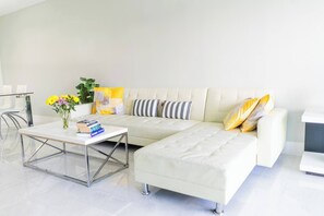 Living area - Sunny Isles ocean-view 1BR: balcony, pool + gym, steps to beach (Sunny Isles Beach)