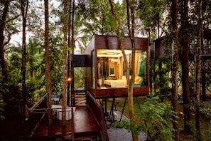 A treehouse with a wooden deck, a staircase, and a bedroom with a bed and a nightstand. - High Tree Resort, Krabi (Krabi)