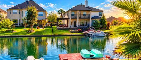 Un quartier résidentiel avec un lac, des bateaux et des maisons.