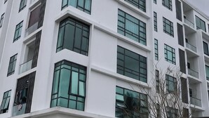 A multi-story building with large windows and a modern architectural style. - Zen66 @ Roxy Serviced Apartment (Kuching)