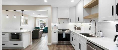 Een microgolfoven, een oven, een kookplaat, een vaatwasser