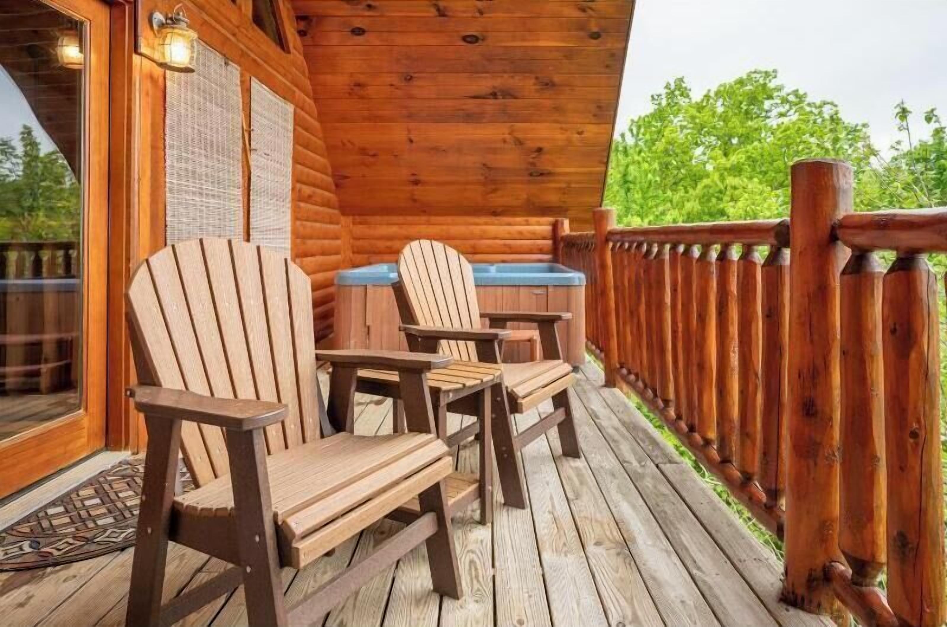 A wooden deck with Adirondack chairs and a hot tub.