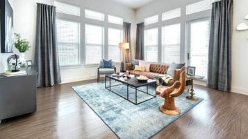 Family Apartment, Balcony, City View | Living area | 50-inch Smart TV with digital channels