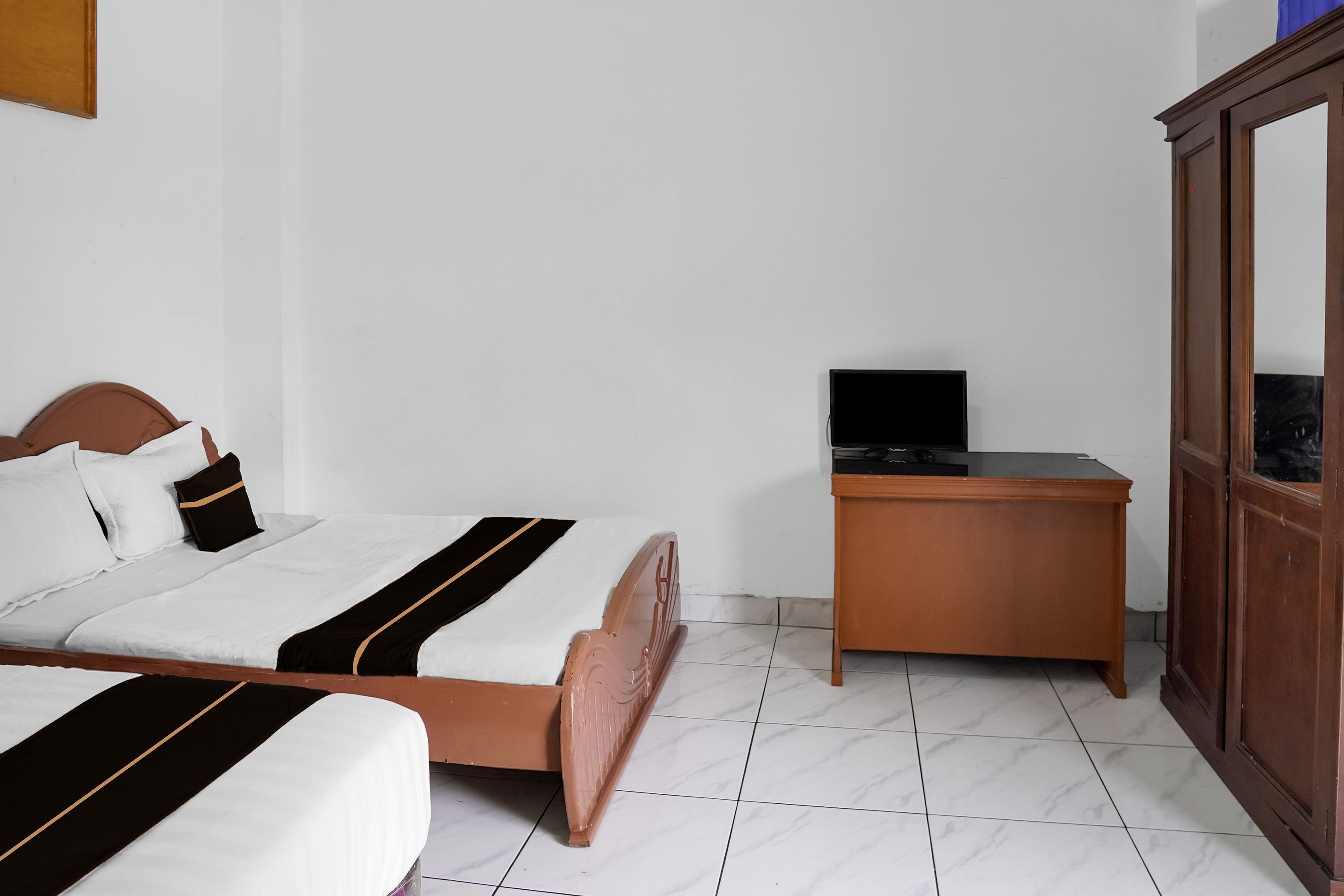 Quarto com cama, escrivaninha e guarda-roupa.