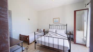 Un dormitorio con cama, mesita de noche y espejo.