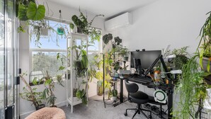 A home office with a desk, computer, and various plants. - Spacious 4-bedroom house with fitness room, sauna, hot tub in vibrant Denver (Denver)