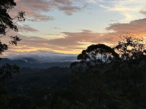Un paysage montagneux, avec une forêt dense et un ciel dégagé.