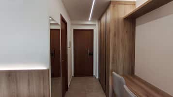 A hallway with wooden doors and a radiator on the right.