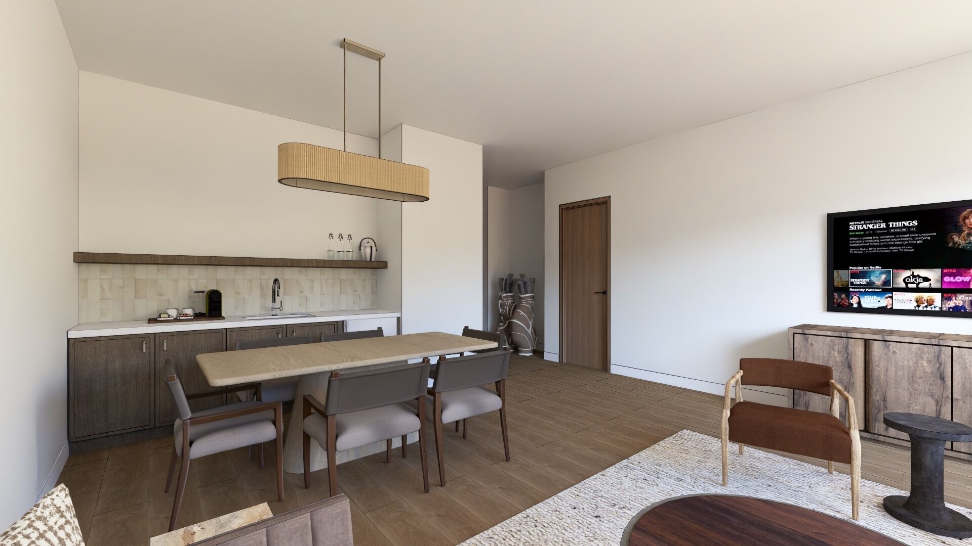 A modern kitchen with a dining area, wooden flooring, and a flat-screen TV displaying a Netflix show.