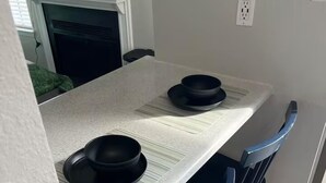 Un comedor con una mesa blanca y sillas azules.