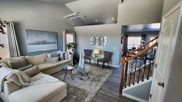 A modern living room with a sofa, coffee table, and decorative items. - Modern Family Getaway with Mountain Views (Colorado Springs)