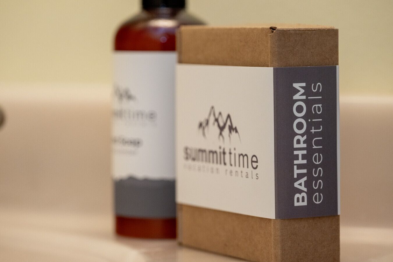 Two boxes labeled 'Summit Time' and 'Bathroom Essentials' on a countertop.