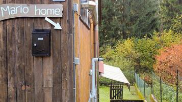A wooden building with a sign reading "Mario home" and a mailbox.