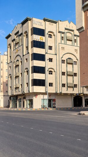 A hotel with a modern facade, multiple balconies, and a prominent 'HOTEL' sign. - MG Crown Hotel 1 (Madinah)