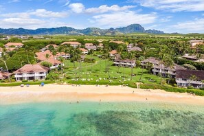 A resort with beachfront properties, a golf course, and lush greenery. - 2/2 BEACHFRONT RESORT w AC, Poipu Bch, Kiahuna Gardenview, Pool/Gym/Courts (Koloa)