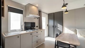 Fridge, microwave, coffee/tea maker, cookware/dishes/utensils