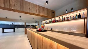 A modern bar area with wooden accents and a variety of liquor bottles.