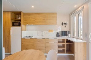 Fridge, microwave, coffee/tea maker, cookware/dishes/utensils